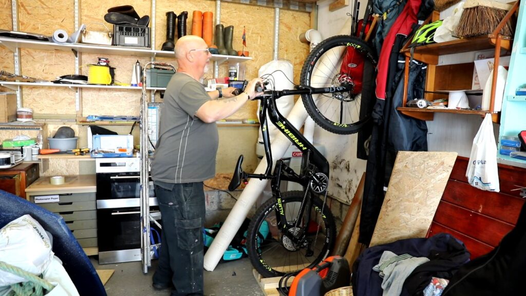 An e-bike owner placing his e-bike in a garage