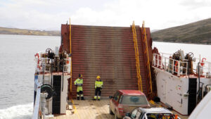 Two workmen talk on the Concordia Bay ferry as it heads to West Falkland
